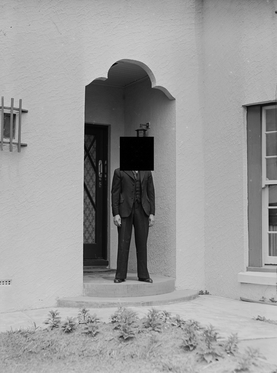Portrait_of_a_man_standing_on_the_doorstep_of_a_house_(AM_75141-1).jpg