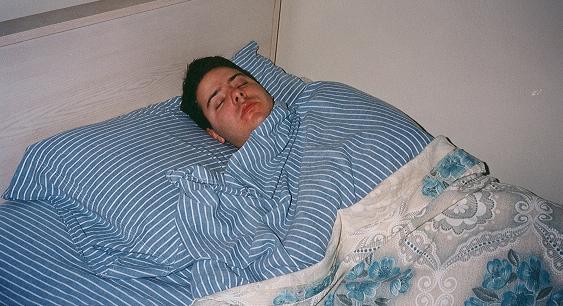 Man_sleeping_striped-sheets.jfif