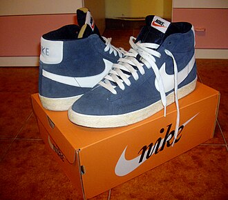 A pair of Nike shoes atop a shoe box.